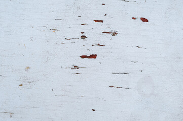 Wooden background, texture with peeling white paint on an uneven surface. Close-up photography, abstraction.