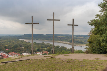 Fototapeta na wymiar Hill of Three Crosses commemorating victims of the plagues that swept through Kazimierz Dolny in the 18th century. The town and River Vistula visible below, Kazimierz Dolny, Poland