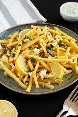 Homemade Greek Fries with Feta and Tzatziki on a Plate, side view.