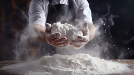 Man kneading dough on wooden background against dark wall.