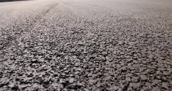 asphalting a new highway with black new asphalt, a close-up of a part of a new paved road