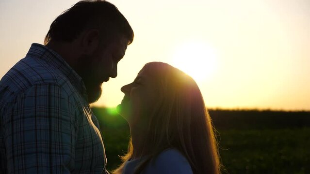 Portrait of happy couple in love hugging each other at countryside. Lovers enjoying beautiful romantic moment at sunset. Young pair spending time together at nature. Loving and happiness concept
