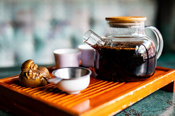 tea pot and Cup of puer tea on table