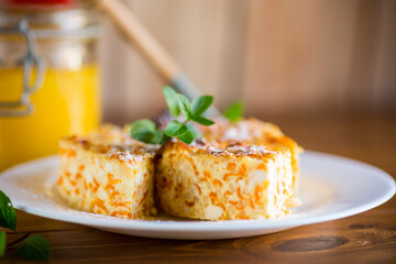 Cooked cottage cheese casserole with pieces of pumpkin inside.