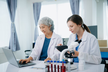 Medical team having a meeting with doctors. Young scientists conducting research investigations in a medical laboratory, a researcher.