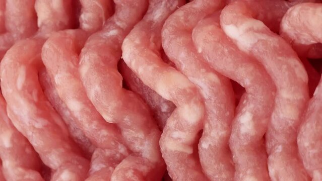 Fresh raw minced meat, rotation. Close-up. Raw chicken (turkey) meat. Vertical video