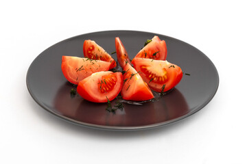 Slices of tomatoes with dill on a plate, on a white background. Close-up. Isolate. Photo