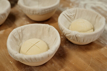 Background image of fresh dough powdered with flour rising in bowls on workstation at bakery kitchen, copy space