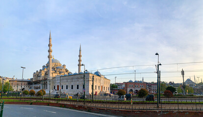 Fototapeta na wymiar Yeni Cami Mosque or New Mosque in Istanbul at sunset, soft light effect. Panoramic view of the muslim architecture in Turkey capital, district of Sultanahmet in old town.