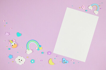 Blank white card on pastel purple background with frame of cute kawaii air plasticine handmade...