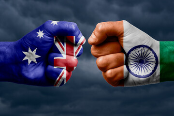 AUSTRALIA vs INDIA confrontation, religious conflict. Men's fists with painted flags of AUSTRALIA...