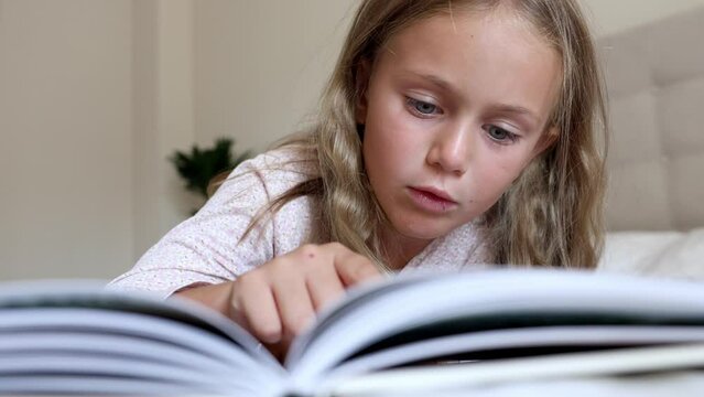 surprise excited toddler girl reading interesting encyclopedia book new facts information. Read for developing smart children. fantasy for kids. Kid emotion
