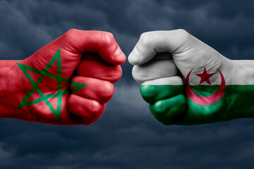 MOROCCO vs ALGERIA confrontation, religious conflict. Men's fists with painted flags of MOROCCO and...