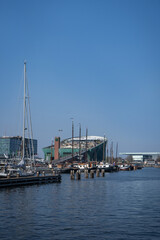 Fototapeta na wymiar Amsterdam, Netherlands - March 29, 2022: NEMO science center of Amsterdam. Maritime museum near Amsterdam Centraal Station. Futuristic building exterior at a sunny day in summer.