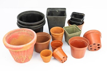 Various sizes, shapes and designs of plastic pots for plants isolated on white background
