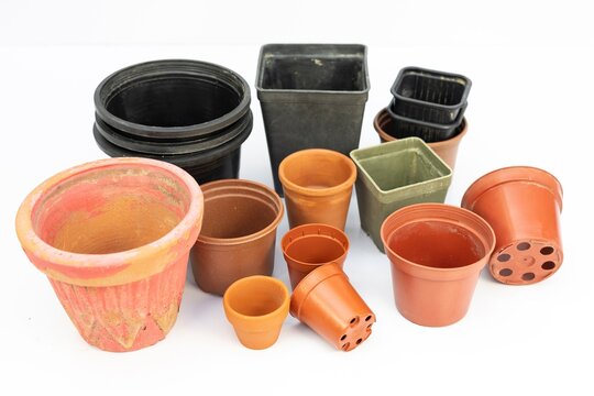 Various sizes, shapes and designs of plastic pots for plants isolated on white background