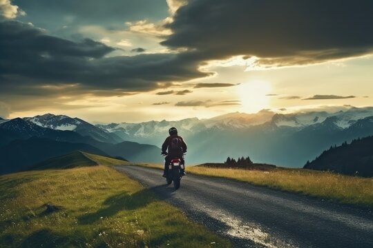 Motorbiker riding in mountains in beautiful sunset