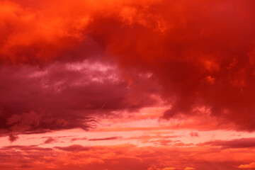 Fototapeta premium Fantastic surreal bright sky with clouds in red and pink colors