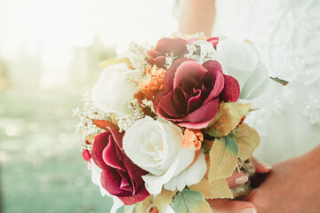 bride holding a purple and white wedding bouquet of flowers. Bride with wedding bouquet 