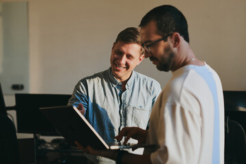 Portrait of two professional male programmers working on computer in diverse offices. Modern IT technologies, development of artificial intelligence, programs, applications and video games concept