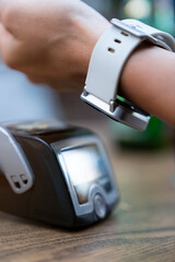 Cropped Hand Of Customer Using Smart Watch For Contactless Payment To Owner At Cafe