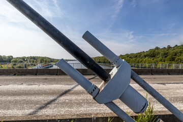 Closeup of huge metal steel anchor of tension cable of Lanaye cable-stayed bridge, rural vehicular...