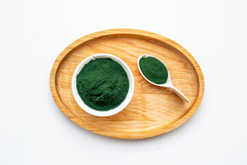 Spirulina algae powder in bowl and spoon, super food, top view