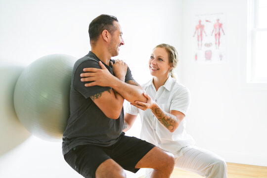 Modern rehabilitation physiotherapy woman with man client