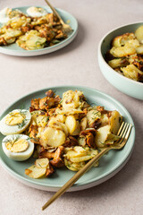 Delicious hearty dinners or lunches, fried young potatoes with forest mushrooms Chanterelles with dill, boiled eggs, seasonal food