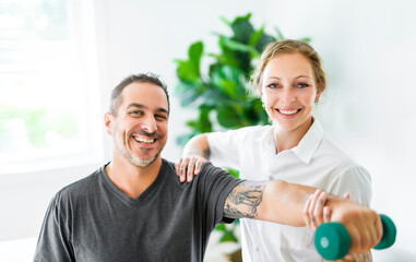 Fototapeta premium Modern rehabilitation physiotherapy woman with man client