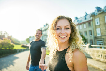 Fototapeta na wymiar Beautiful couple having fun outdoors on urban background