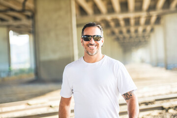 portrait caucasian man outside on industrial urban background
