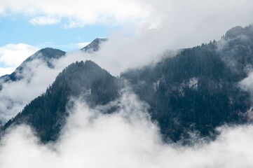 Picturesque foggy landscape, over mountainous terrain below