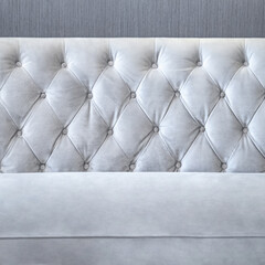 Closeup of a modern white velvet sofa in the living room. Front view couch surface background for design element