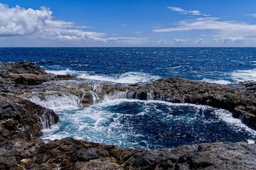 Scenic view of a rocky shoreline in a tranquil blue seascape