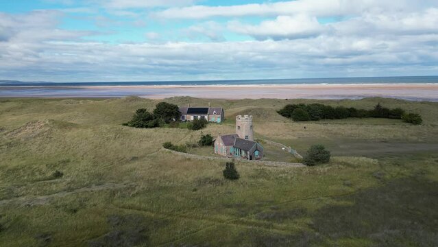 Aerial footage over the stable and tower at Snook House in Holy Island, Northumberland, UK
