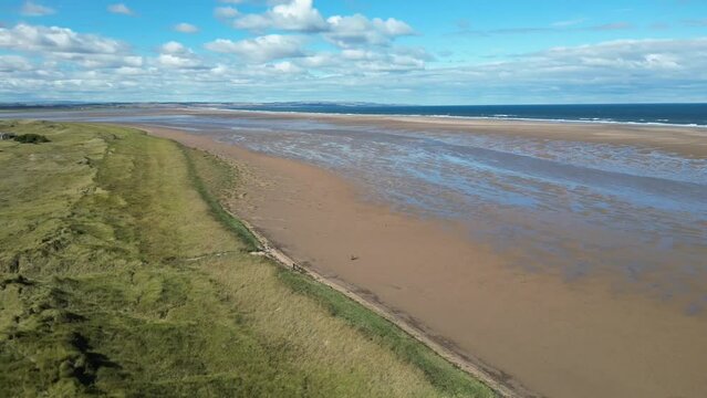 Drone footage over the shoreline of Holy Island on a sunny day in Northumberland, UK