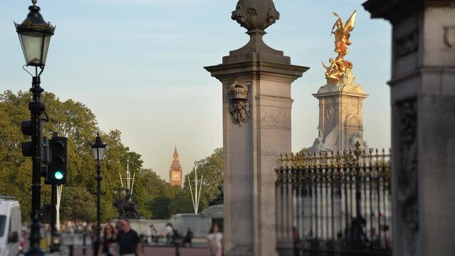 Victoria Memorial by Buckingham Palace and view down the Mall to Big Ben.
Late afternoon sun illuminates the gold statue commemorating Queen Victoria and, in the distance, Big Ben.