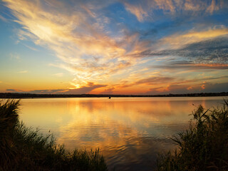 Obraz premium Vibrant sky reflecting on a calm and serene lake