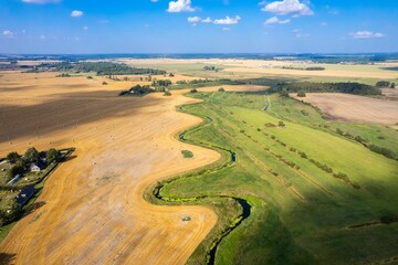Aerial view of harvest field with hey bales