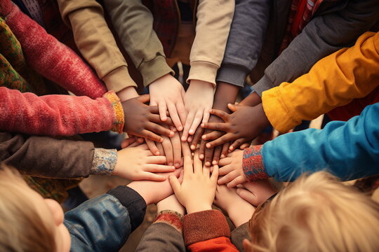 many child hands touch together in a circle