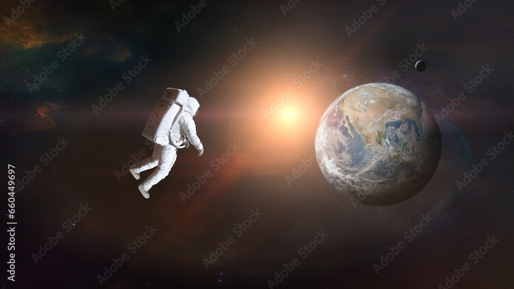Wall mural cosmonaut in outer space on earth background with sunlight. elements of this image furnished by nasa