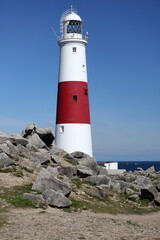 Fototapeta na wymiar Vertical photo of the lighthouse at Portland Bill near Weymouth on the Jurassic Coast in Dorset, England.