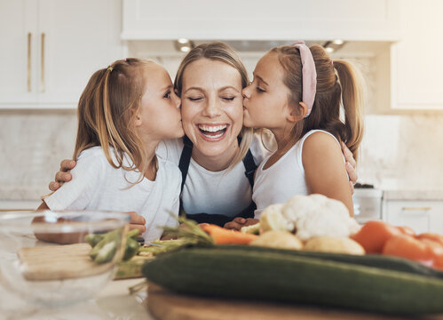 Home, cooking and mother with children, kissing and care with bonding, healthy food and weekend break. Family, mama or children with mom, kids and ingredients with a smile, kitchen or relax with love