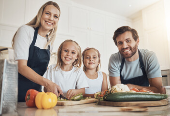 Obraz na płótnie Canvas Family portrait, smile and cooking in kitchen with vegetables for lunch, diet and nutrition. Happy parents and children, food and ingredients for meal prep, healthy and teaching the kids at home