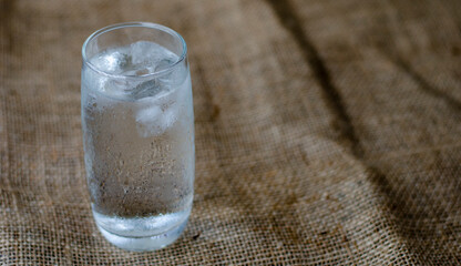 Cold drinking water with ice in a clean glass, drink healthy and cool down. with copy space