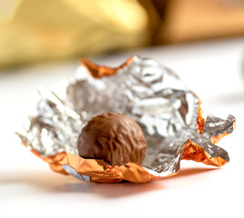 chocolate praline in a gold foil