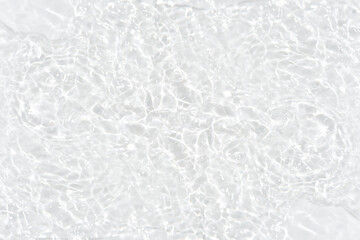 Defocus blurred transparent white colored clear calm water surface texture with splashes reflection. Trendy abstract nature background. Water waves in sunlight with copy space. Blue watercolor shine.