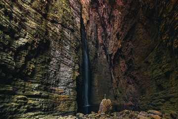 
man on top of a rock admiring Cachoeira da Fumacinha, Vale do Pati, Chapada Diamantina, Bahia,...