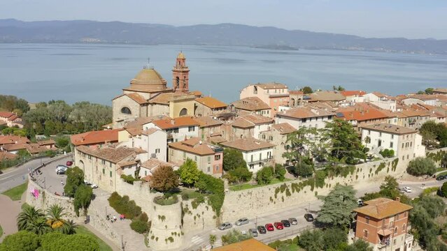 Aerial view on church of Santa Maria Maddalena in historical center of Castiglione del Lago, in Umbria, Italy. The church has a large dome and is located on Lake Trasimeno in the province of Perugia.